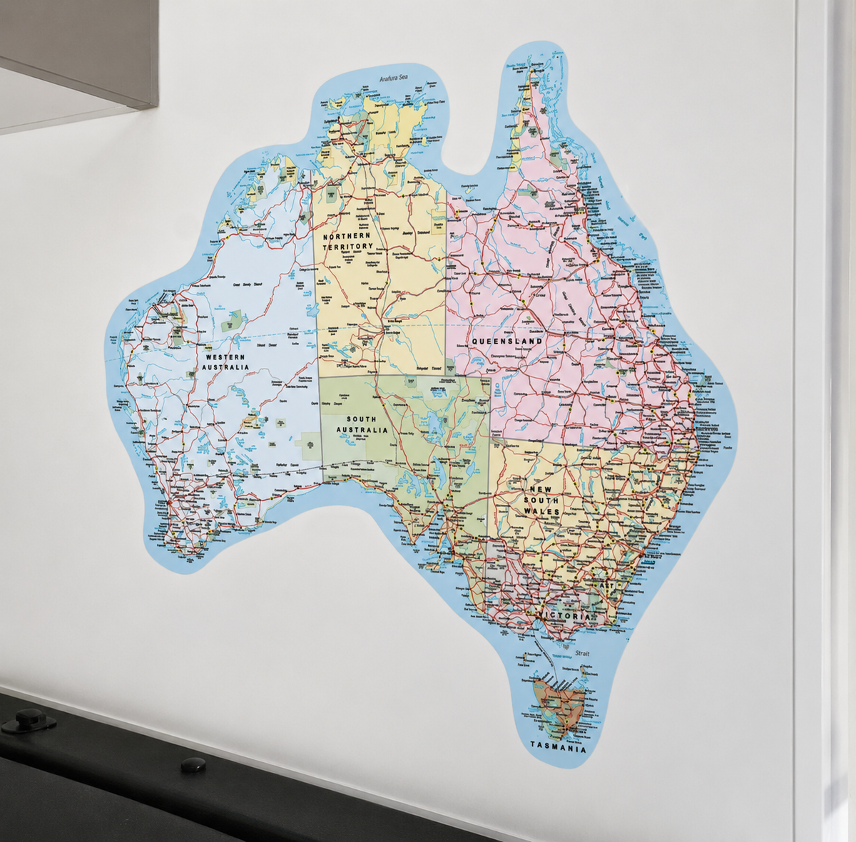 A large, die-cut wall map of Australia Decal in a multicolour print, stuck on a caravan wall.