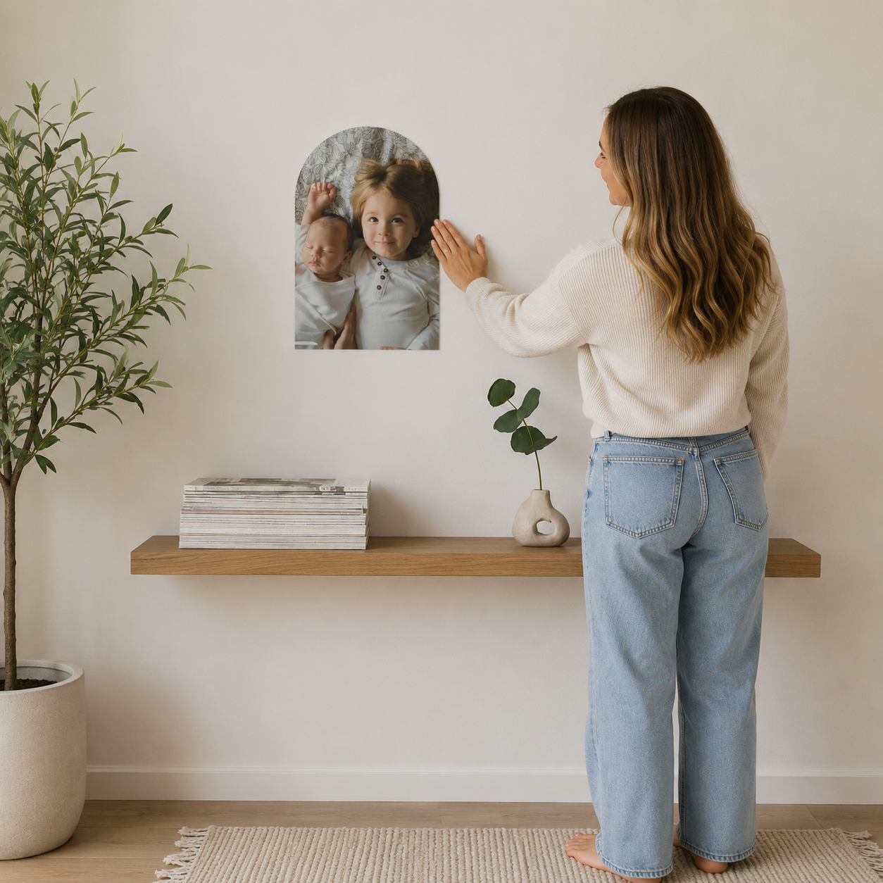 Custom arched photo wall decal on a beige wall above a wooden shelf.